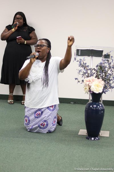 Kneeling in prayer at the front of the sanctuary.
