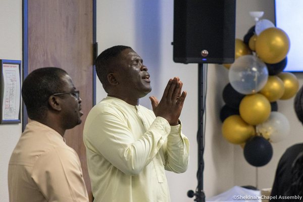 Hands raised together in prayer.