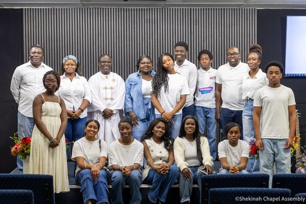 The Shekinah Assembly church family together after a Sunday service.